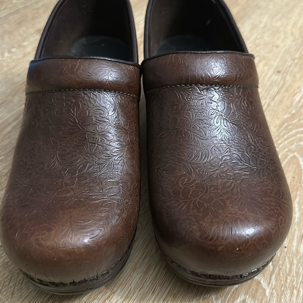 Brown leather floral work clogs.